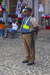 A Panamanian policeman watches the crowd at Devils and Congos festival, Portobello, Coln, Panama, Central America - photo by H.Olarte