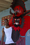 A congo culture man shows a devil mask, which represents the 'oppresor' white Spanish man, during the bi annual meeting of Devils and Congos, Portobello, Coln, Panama, Central America - photo by H.Olarte