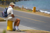 Panama City: an American tourist takes a roadside rest in Panama's Amador Causeway - photo by H.Olarte