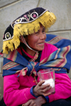 Ausangate massif, Cuzco region, Peru: Quechua woman drinks the local brew in a rural town - Chicha de jora, a fermented beverage derived from maize - photo by C.Lovell