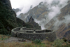 Runkuraquay, Cuzco region, Peru: fog hangs below the Inca ruins of Runkuraqay which were a lookout and tambo (travelers lodge) - Inca Trail - Peruvian Andes - photo by C.Lovell