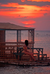 Philippines - Beach - sunset - girl relaxing - benches - photo by B.Henry