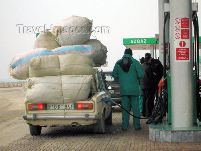 azer172: Salyan road, Azerbaijan: petrol station - overloaded car gets some gasoline - Lada - photo by F.MacLachlan - (c) Travel-Images.com - Stock Photography agency - Image Bank