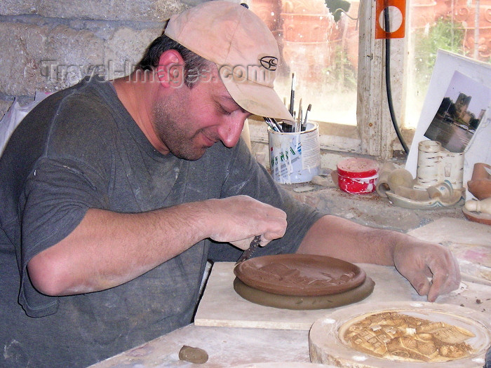 azer221: Azerbaijan - Baku: potter finishing a picture of Baku - pottery on the road to the airport - artisan - clay - photo by F.MacLachlan - (c) Travel-Images.com - Stock Photography agency - Image Bank