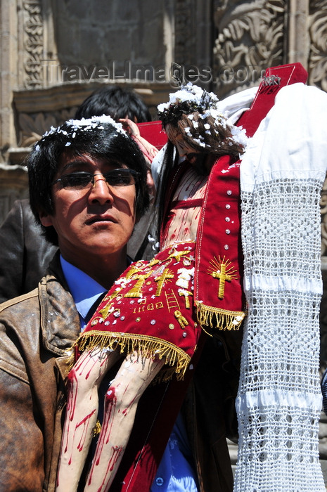bolivia61: La Paz, Bolivia: man outside San Francisco church, holding with large crucifix, after thanking God for a granted request - Paceño - photo by M.Torres - (c) Travel-Images.com - Stock Photography agency - Image Bank