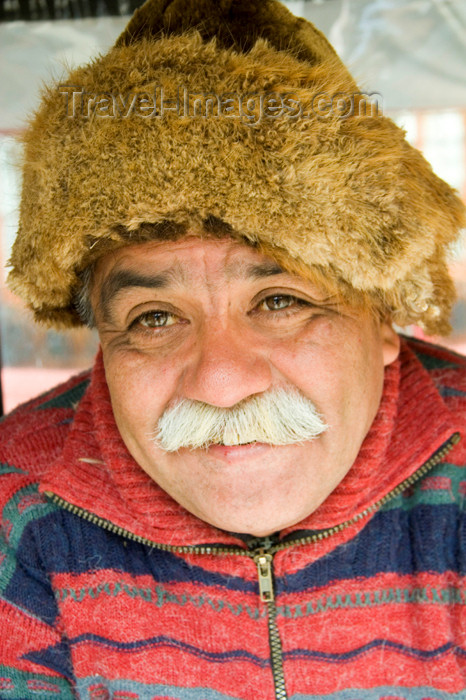 chile122: Punta Arenas, Chile: old Chilean man with mustache and wearing a beaver hat in a market stall - photo by D.Smith - (c) Travel-Images.com - Stock Photography agency - Image Bank