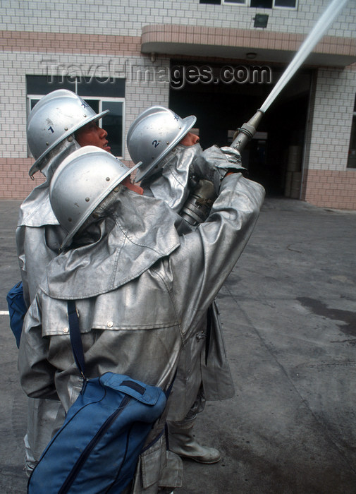 china244: Dongguan, Guangdong province, China: Chinese firemen - with hose - photo by B.Henry - (c) Travel-Images.com - Stock Photography agency - Image Bank