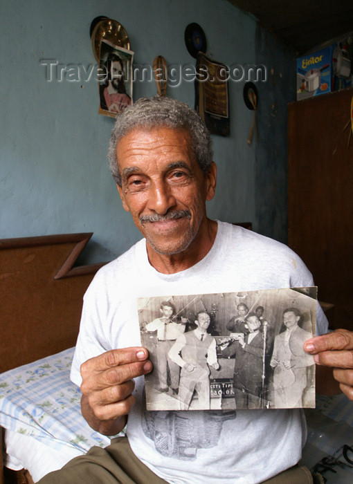 cuba81: Cuba - Holguín - this musician proudly shows off a photo of him and his band in his glory days - Cuban Band Leader - photo by G.Friedman - (c) Travel-Images.com - Stock Photography agency - Image Bank