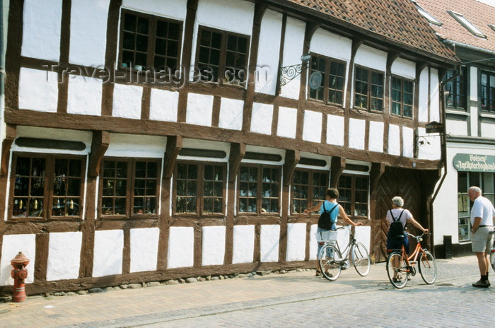 denmark32: Odense, Funen island, Syddanmark, Denmark: people walking their bikes in front of a timber structure building - photo by K.Gapys - (c) Travel-Images.com - Stock Photography agency - Image Bank
