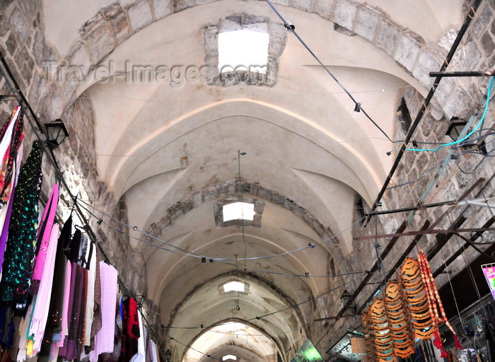 israel476: Jerusalem, Israel: Souq Al Qattanin / Suq El Qatanin, i.e. Market of the Cotton Merchants, aka Suq of Amir Tankaz al-Nasiri - vaulted roof and hanging textiles, arched ceiling with a barrel-shaped vault divided into sections with skylights, for ventilation and illumination - Crusader market improved by the Mamluks - the suq contains a caravanserai, two hammams, and two rows of 30 shops - west side of the Haram al-Sharif, Muslim Quarter - photo by M.Torres - (c) Travel-Images.com - Stock Photography agency - Image Bank