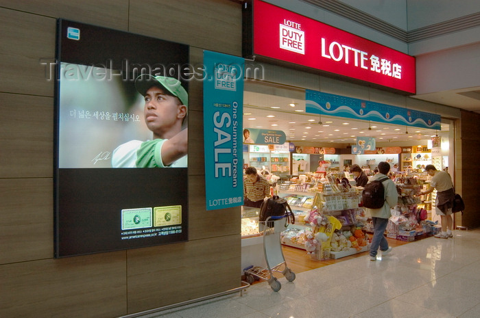koreas80: Seoul, South Korea: airport terminal Lotte duty free store with Tiger Woods advertisement for American Express - Lotte sale - Incheon International Airport - photo by C.Lovell - (c) Travel-Images.com - Stock Photography agency - Image Bank