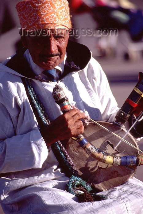 moroc1: Morocco / Maroc - Marrakesh: musician on the Place Djemaa el Fna - Moroccan musical instrument - rebab - photo by F.Rigaud - (c) Travel-Images.com - Stock Photography agency - Image Bank
