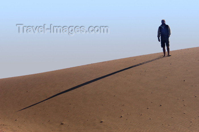 namibia164: Namibia: Man on sand dune casting long morning shadow, Skeleton Coast - photo by B.Cain - (c) Travel-Images.com - Stock Photography agency - Image Bank
