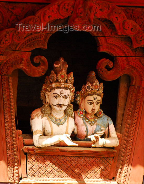 nepal148: Kathmandu, Nepal: wood statues of royal couple at the window, in a pose similar to Shiva and Parvati, in a pagoda temple roof strut, near Durbar Square - photo by E.Petitalot - (c) Travel-Images.com - Stock Photography agency - Image Bank