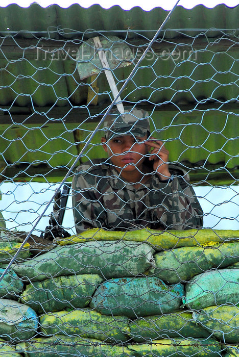 nepal187: Pokhara, Nepal: sand bags and soldier behind chicken wire in the Pokhara garrison - photo by E.Petitalot - (c) Travel-Images.com - Stock Photography agency - Image Bank
