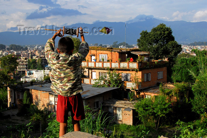 nepal215: Kathmandu, Nepal: boy flying a kite over the city - photo by J.Pemberton - (c) Travel-Images.com - Stock Photography agency - Image Bank
