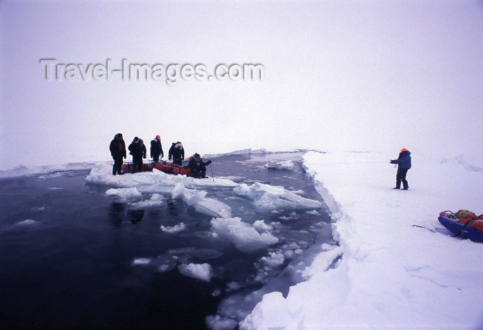 north-pole10: Arctic Ocean: using a block of ice as a raft to cross a lead of open water - North Pole expedition (photo by Eric Philips) - (c) Travel-Images.com - Stock Photography agency - Image Bank