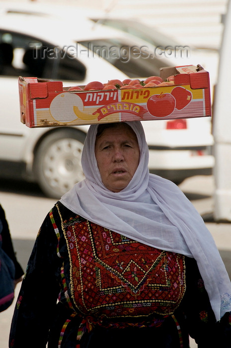 palest29: Hebron, West Bank, Palestine: Palestinian woman in traditional dress transporting a box of Israeli tomatoes - photo by J.Pemberton - (c) Travel-Images.com - Stock Photography agency - Image Bank