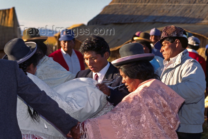 peru111: Lake Titicaca, Puno department, Peru: Aymara dancing around the newlyweds – Aymara wedding on the main floating island - photo by C.Lovell - (c) Travel-Images.com - Stock Photography agency - Image Bank