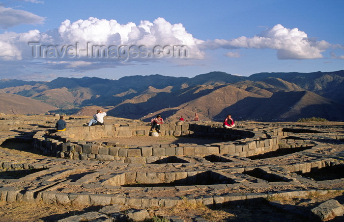 peru133: Cuzco, Peru: people sit on the foundation of Muyucmarca, one of  Sacsayhuaman's three great towers - view of the mountains - photo by C.Lovell - (c) Travel-Images.com - Stock Photography agency - Image Bank