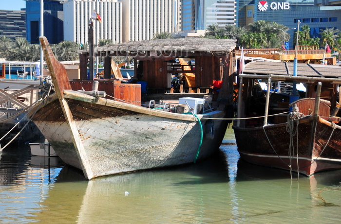 qatar39: Doha, Qatar: prow view of dhows in the Dhow harbour - Corniche in the background - Qatar National Bank building - photo by M.Torres - (c) Travel-Images.com - Stock Photography agency - Image Bank