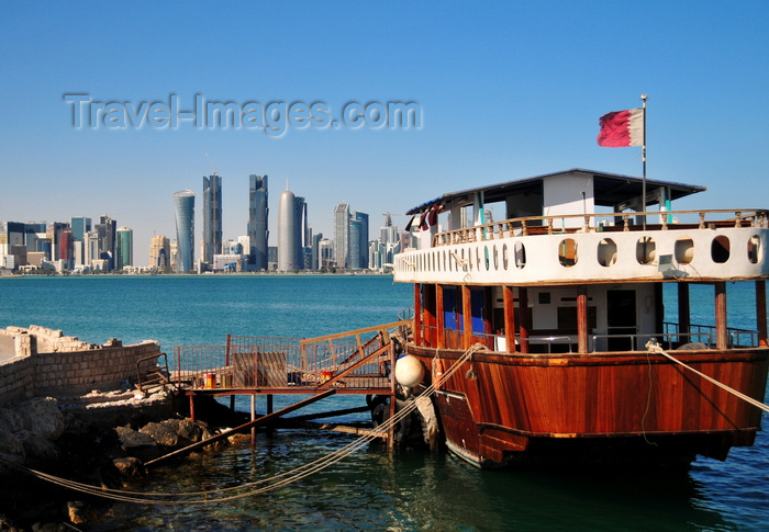qatar50: Doha, Qatar: old boat with Qatari flag in the Dhow harbour - West Bay skyline from the south side of Doha Bay - photo by M.Torres - (c) Travel-Images.com - Stock Photography agency - Image Bank