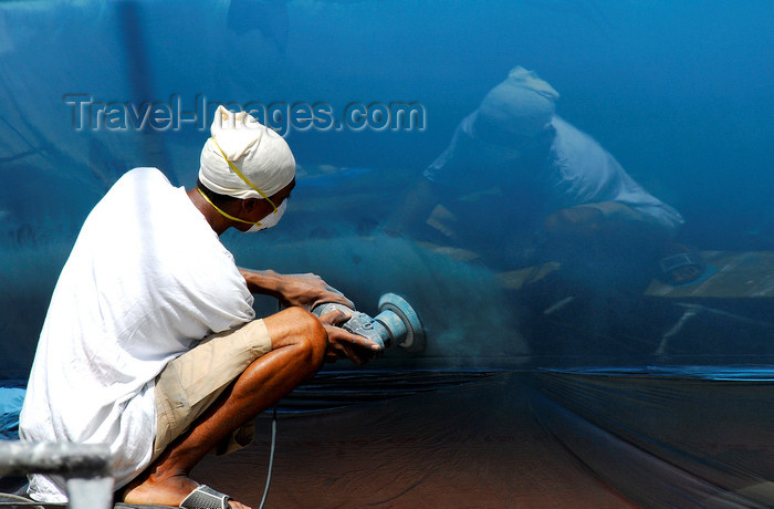 trinidad-tobago51: Port of Spain, Trinidad: worker polishing the hull of a sailing boat - photo by E.Petitalot - (c) Travel-Images.com - Stock Photography agency - Image Bank
