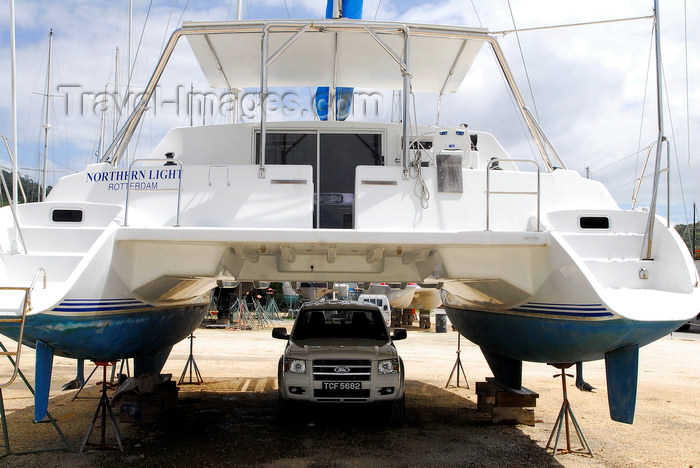 trinidad-tobago68: Port of Spain, Trinidad: catamaran undergoing repairs used like a garage at the harbour - Northern Light - photo by E.Petitalot - (c) Travel-Images.com - Stock Photography agency - Image Bank