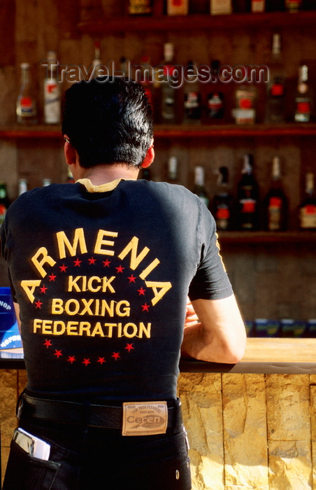 ukra97: Odessa, Ukraine: young man standing at bar counter, rear view - jeans and t-shirt reading 'Armenia Kick Boxing Federation' - photo by K.Gapys - (c) Travel-Images.com - Stock Photography agency - Image Bank