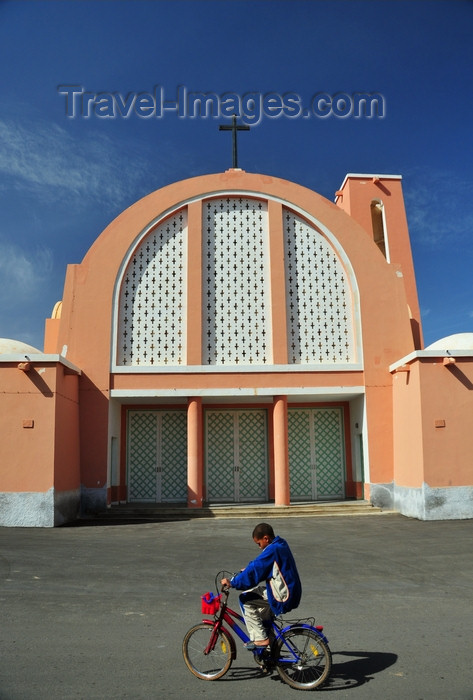 western-sahara128: Laâyoune / El Aaiun, Saguia el-Hamra, Western Sahara: Spanish Cathedral - Sahrawi boy on a bike - photo by M.Torres - (c) Travel-Images.com - Stock Photography agency - Image Bank