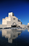 Doha, Qatar: limestone facade of the Museum of Islamic Art reflected in the pond - Doha's flagship museum - photo by M.Torres