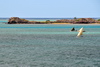 Hermitage Island, Rodrigues island, Mauritius: islet, horizon and fishing boats with latin sails - photo by M.Torres