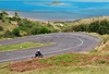 Pompe, Rodrigues island, Mauritius: motorbike climbing the winding road - lagoon and Hermitage island in the background - photo by M.Torres