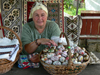 Gura Humorului, Suceava county, southern Bukovina, Romania: decorated eggs and textiles - woman at souvenir stall - photo by J.Kaman