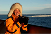 Russia - Bering Strait (Chukotka Autonomous Okrug): cruise passenger enjoys Arctic sun - camera - photo by R.Eime