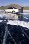Lake Baikal, Irkutsk oblast, Siberian Federal District, Russia: car on the frozen lake surface - locals routinely drive on the ice - photo by B.Cain