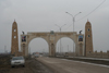 Chechnya, Russia - Grozny - city gates with posters of Putin and Kadirov Sr - GAZ Volga automobile on the left - photo by A.Bley