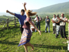 Chechnya, Russia - man and woman dancing traditional Chechen dance in meadow - photo by A.Bley
