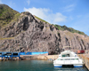 Fort Bay, Saba: catamaran Samantha in the harbour - cliffs - photo by M.Torres