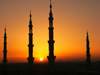 Medina / Madinah, Saudi Arabia: sun and silhouette of minarets of Masjid Al Nabawi or Nabawi Mosque - photo by A.Faizal