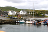 Scotland - Islay Island - Port Ellen: a view of part of the harbor with small boats moored to the wharf and the town in the background - photo by C.McEachern
