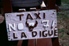 Seychelles - La Digue island: bovine taxi - license plate - photo by F.Rigaud