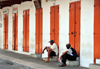 Mahe, Seychelles: idle time on Market street - men and red doors - photo by M.Torres