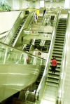 Singapore: Commuters navigate escalators at one of the Mass Rapid Transit (MRT) stations (photo by R.Eime)
