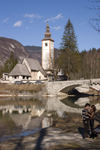 Slovenia - Ribcev Laz - couple, St John's church and bridge - Bohinj Lake in Spring - photo by I.Middleton