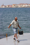 Slovenia - Piran: getting a bucket of sea water - photo by I.Middleton