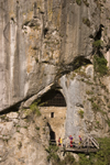 Men going potholing in cave under Predjama castle , Slovenia - photo by I.Middleton