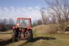 Slovenia - Pivka Valley: farmer driving tractor - Karst region - photo by I.Middleton