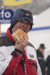 Hungry man eating large hamburger at Planica ski jumping championships, Slovenia - photo by I.Middleton