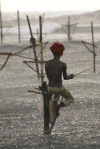 Weligama, Southern Province, Sri Lanka: stilt fisherman in the rain - photo by B.Cain